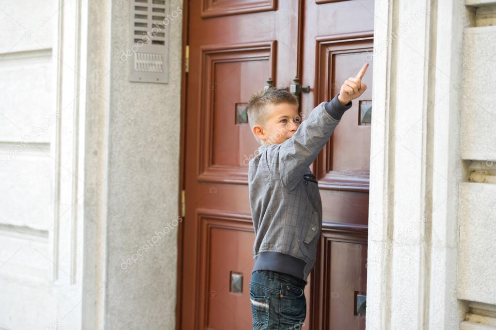 Boy ringing doorbell