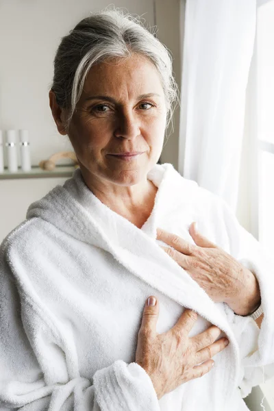 Äldre kvinna i vit morgonrock — Stockfoto
