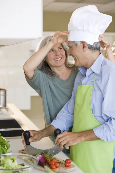 Äldre par spela medan matlagning — Stockfoto