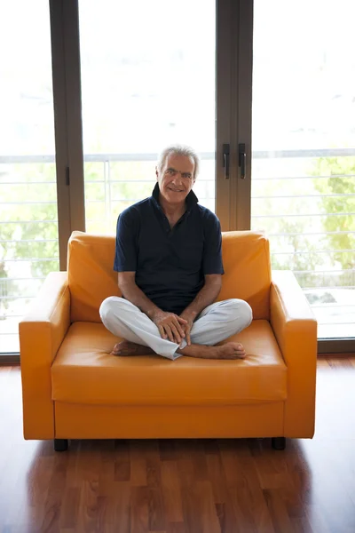 Senior man on a sofa — Stock Photo, Image