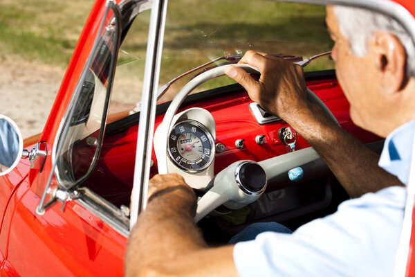 Senior man in vintage car