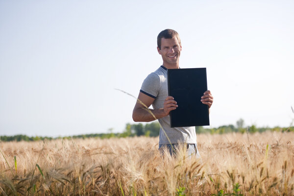 Young man holding a solar panel