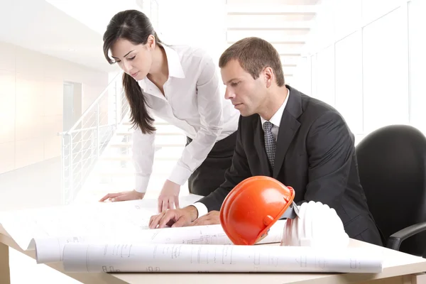 Business people working on blue prints — Stock Photo, Image