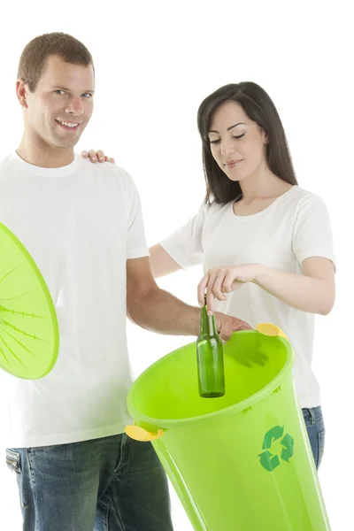 Young couple recycling glass bottles — Stock Photo, Image
