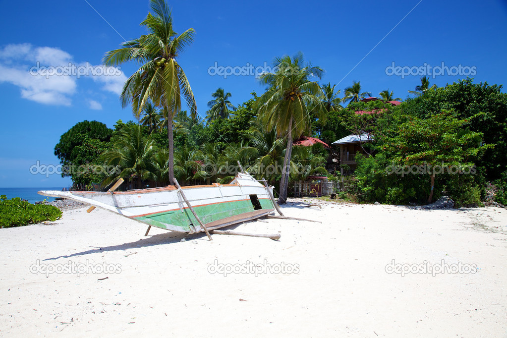 Banca boat on white sand tropical beach on Malapascua island, Philippines