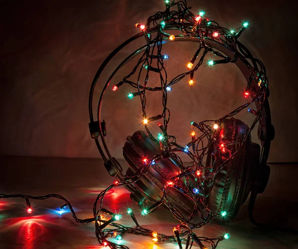 Headphones Wrapped Garland Glowing Lights Dark Background — Stockfoto