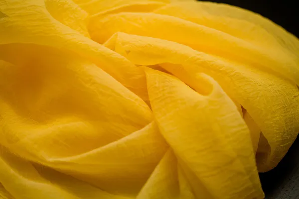 Yellow silk tender colored textile, elegance rippled material — Stock Photo, Image