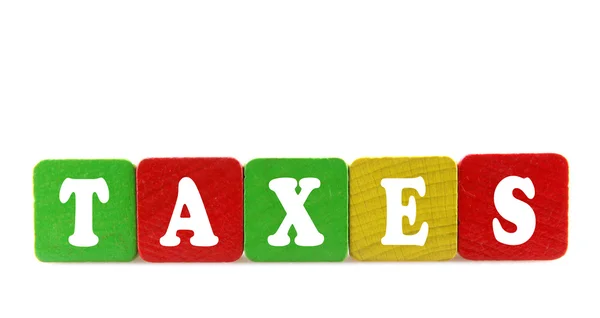 Taxes - isolated text in wooden building blocks — Stock Photo, Image