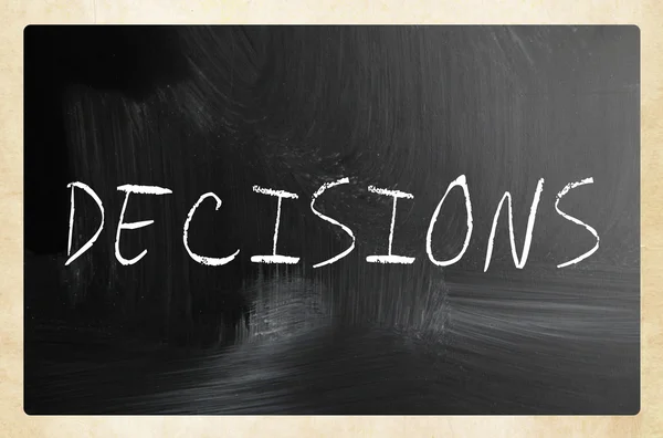 The word "Decisions" handwritten with white chalk on a blackboar — Stock Photo, Image