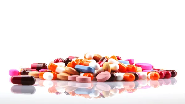 Tablets and capsules on a white background — Stock Photo, Image