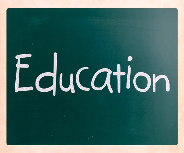 The word "Education" handwritten with white chalk on a blackboar — Stock Photo, Image