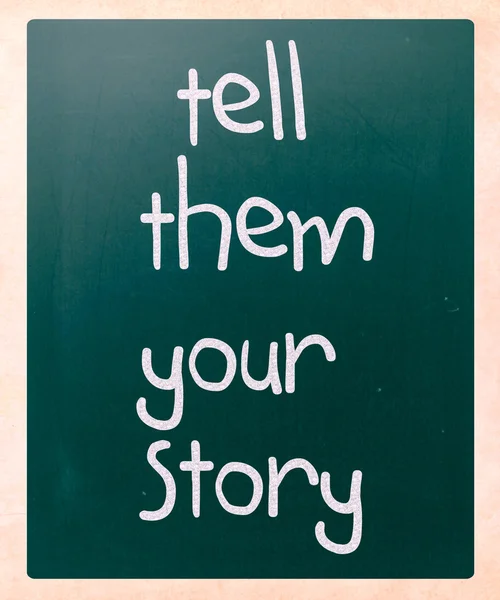 "Tell them your story" handwritten with white chalk on a blackbo — Stock Photo, Image