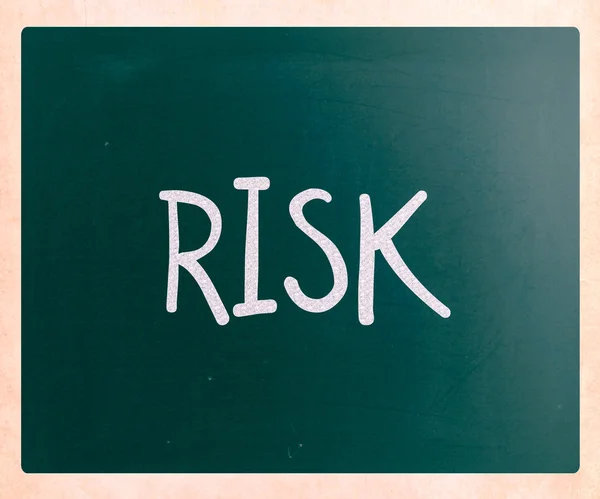 The word "Risk" handwritten with white chalk on a blackboard — Stock Photo, Image