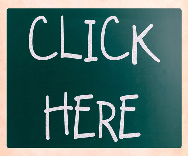 "Click here" handwritten with white chalk on a blackboard — Stock Photo, Image