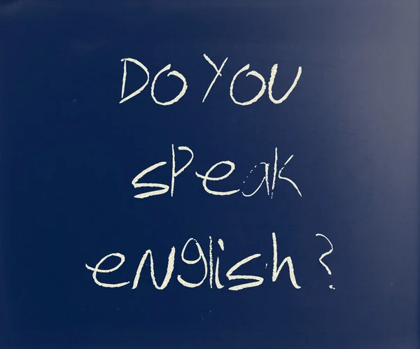 "Do you speak english "handwritten with white chalk on a blackbo — стоковое фото