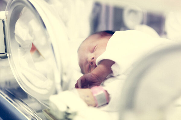 Newborn baby inside incubator