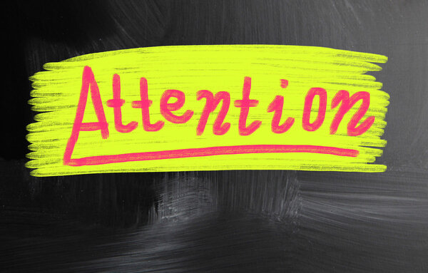 attention handwritten with chalk on a blackboard