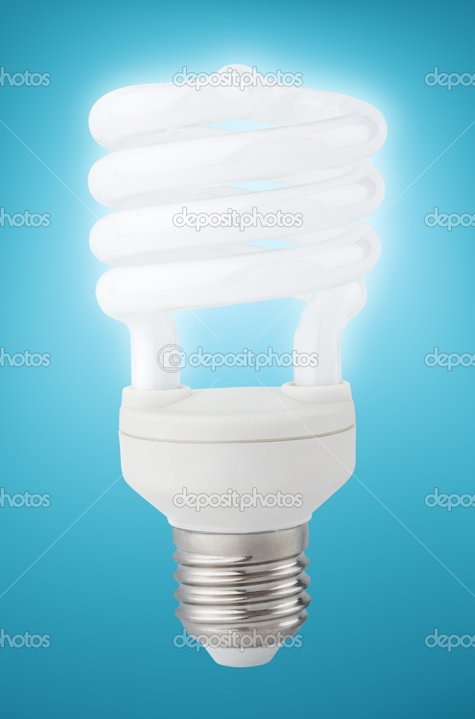 Energy saving fluorescent light bulb on blue