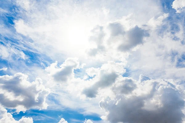 Sun in clouds on blue sky — Stock Photo, Image