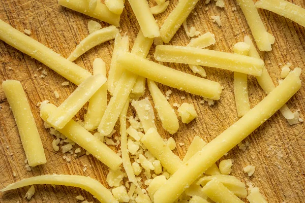 Grated cheddar cheese background closeup — Stock Photo, Image