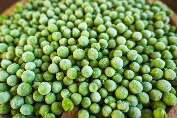 Gefrorene frostige grüne Erbsen Hintergrund Nahaufnahme — Stockfoto