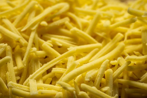 Fondo rallado queso cheddar primer plano —  Fotos de Stock