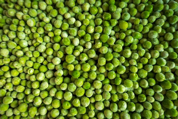 Gefrorene frostige grüne Erbsen Hintergrund Nahaufnahme — Stockfoto