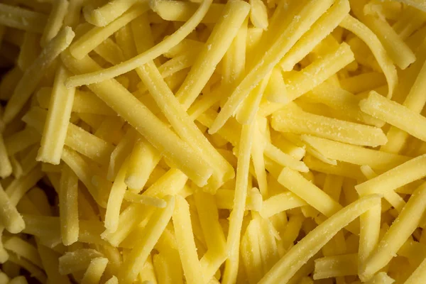 Formaggio cheddar grattugiato sfondo primo piano — Foto Stock