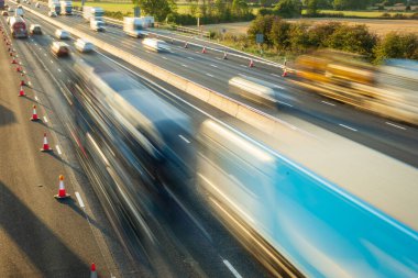 heavy traffic in blurry motion on UK motorway in England. clipart