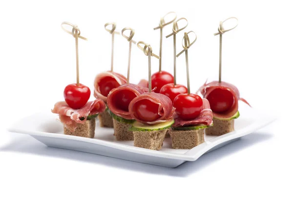 Canapes with tomato and bacon — Stock Photo, Image