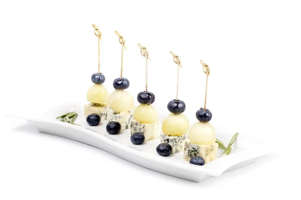 Canapes on a plate with cheese melon and blueberries — Stock Photo, Image