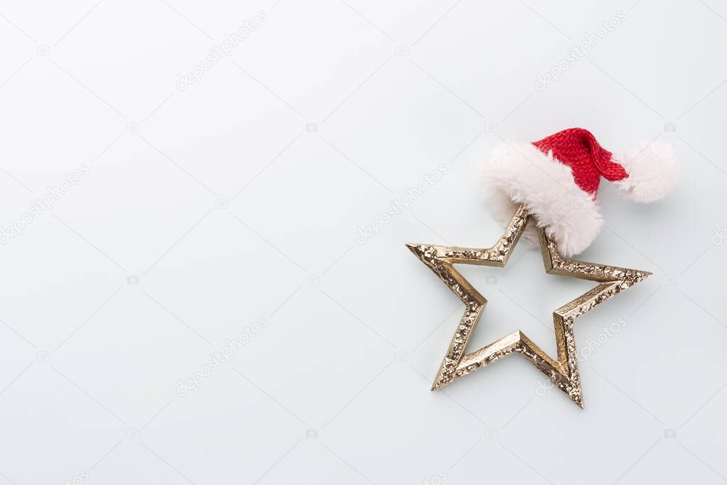 Christmas star and santa hat, decor on pastel blue background. 