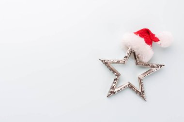 Noel yıldızı ve Noel Baba şapkası, pastel mavi arka planda dekor. 