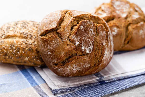 stock image Freshly baked bread on dark gray kitchen table, top view.