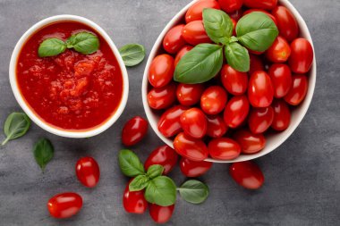 Pasta masasında taze domatesler. Domates arka planı, sağlıklı sebze ve fesleğen yaprakları..