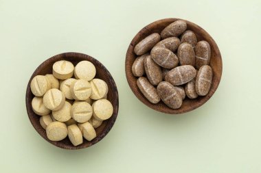 Vitamin hapı tableti, mineral ve takviye maddesi, bitkisel ilaç tozu tıp pastel arka planında fotokopi alanı ile birlikte..