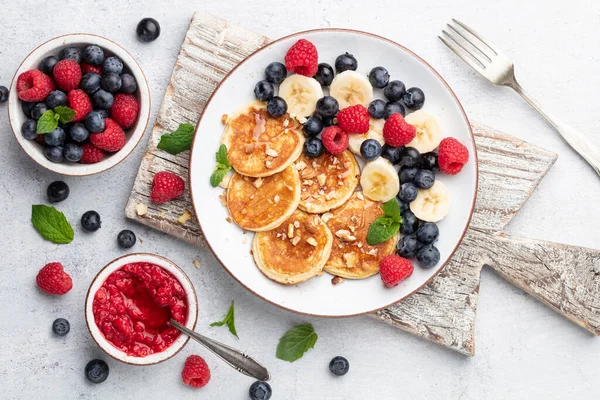 Keto pancakes made of diet flour or almond flour, served with berries.