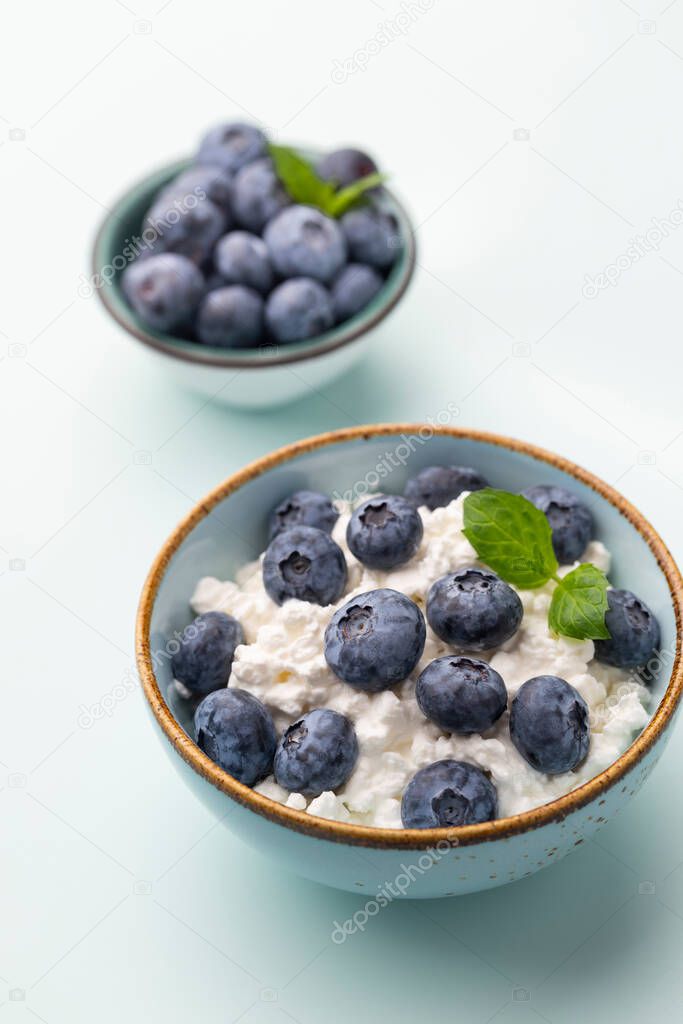 Cottage cheese with blueberry, fresh berries, keto healthy breakfast concept, top view.