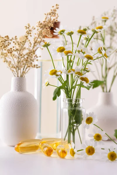 Chamomile flowers with bottle. Natural herbs medicine. Herbal medicine. Homeopathy end alternative medicine backgrouns.