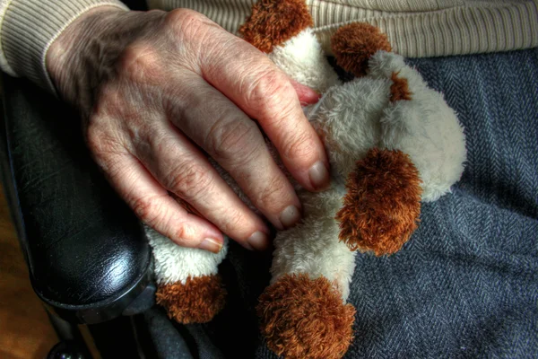 Elderly hand with doll 04