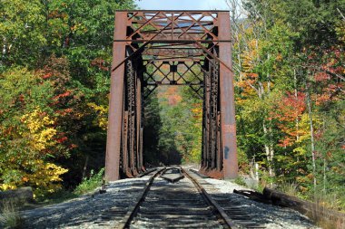 Rusty old train bridge in the fall on a sunny day