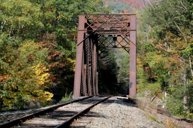 Rusty old train bridge in the fall on a sunny day
