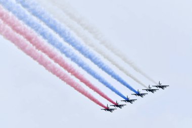 St. Petersburg, Rusya - 25 Temmuz 2021: 6 Rus askeri uçağı havada uçuyor. St. Petersburg dumanı üzerinde gökyüzündeki savaşçılar Rusya bayrağını gösteriyor. Donanma geçit töreninde savaş uçakları.