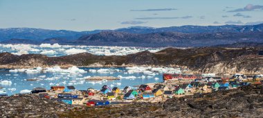 View from a nearby hill, overlooking the town of Illulisat, West Greenland .  clipart