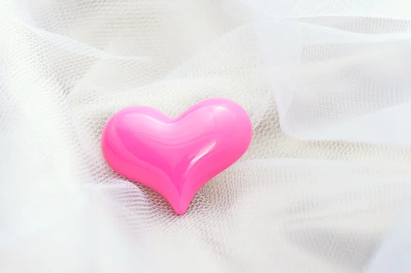 Pink heart on a white veil — Stock Photo, Image