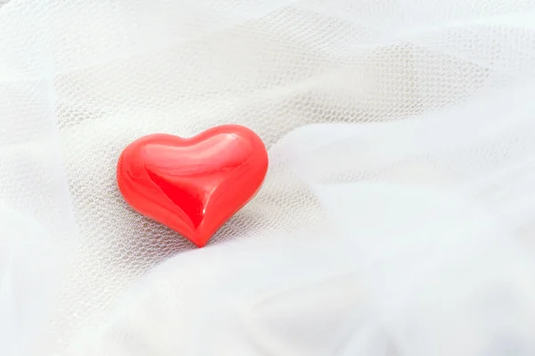 Red heart on a white veil — Stock Photo, Image