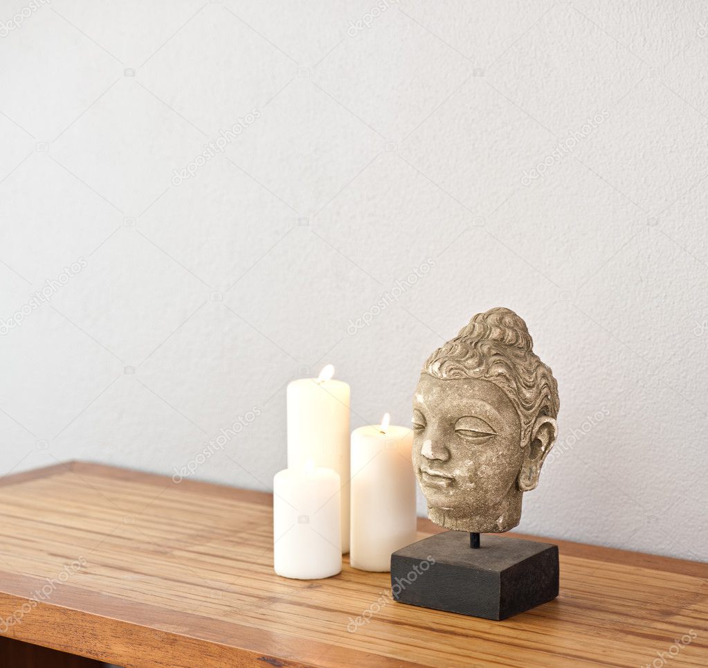 Buddha head with candles 