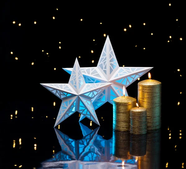 Αναδρομικά φωτισμένη αστέρια σε μπλε χρώμα με χρυσά κεριά — Φωτογραφία Αρχείου