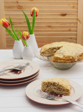 Lasagna's layers with ingredients on a white table.