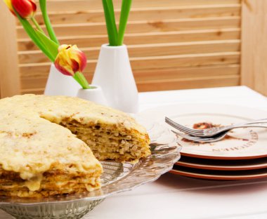 Lasagna's layers with ingredients on a white table.